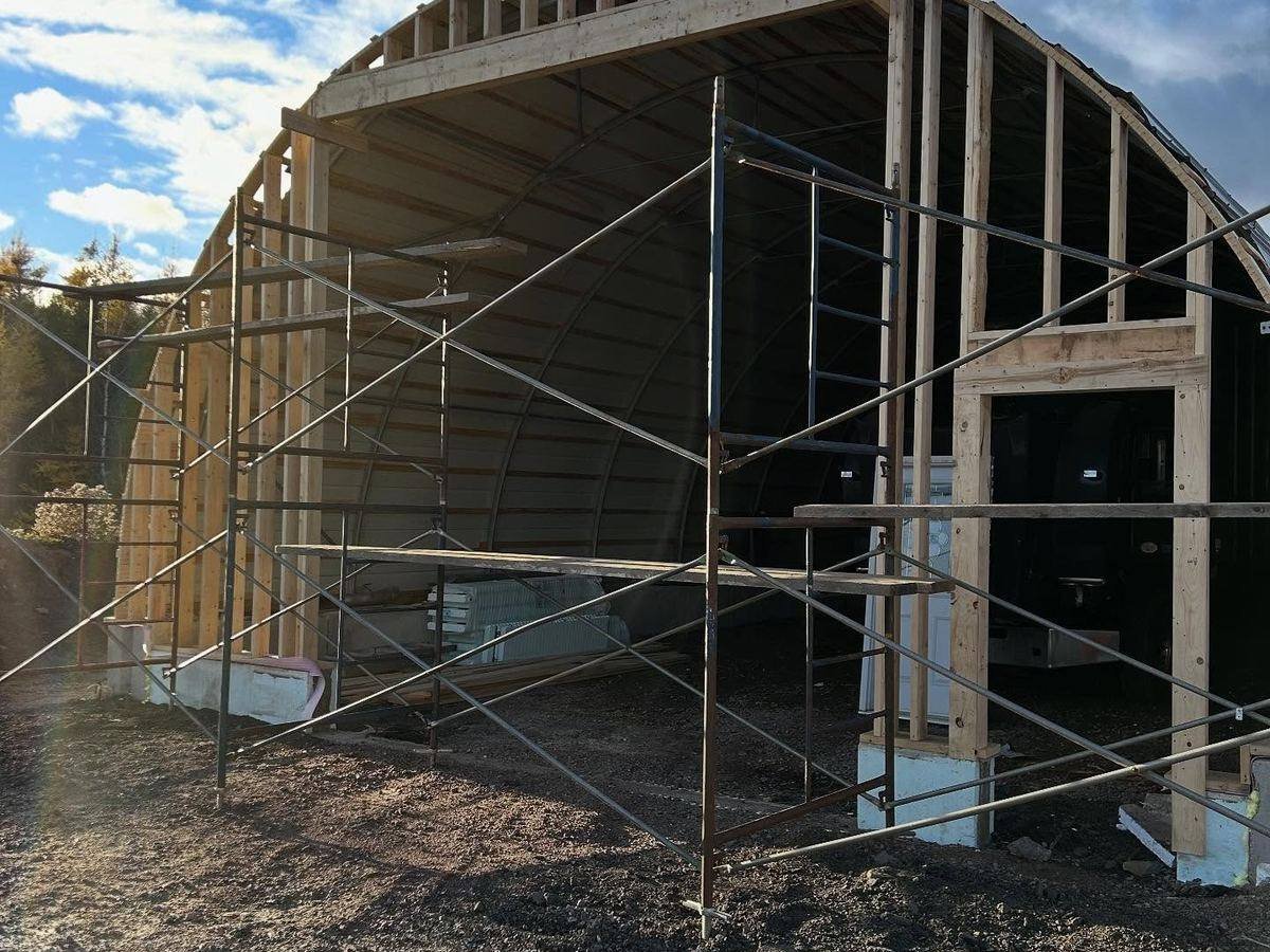 Arched structure being framed on a rural site