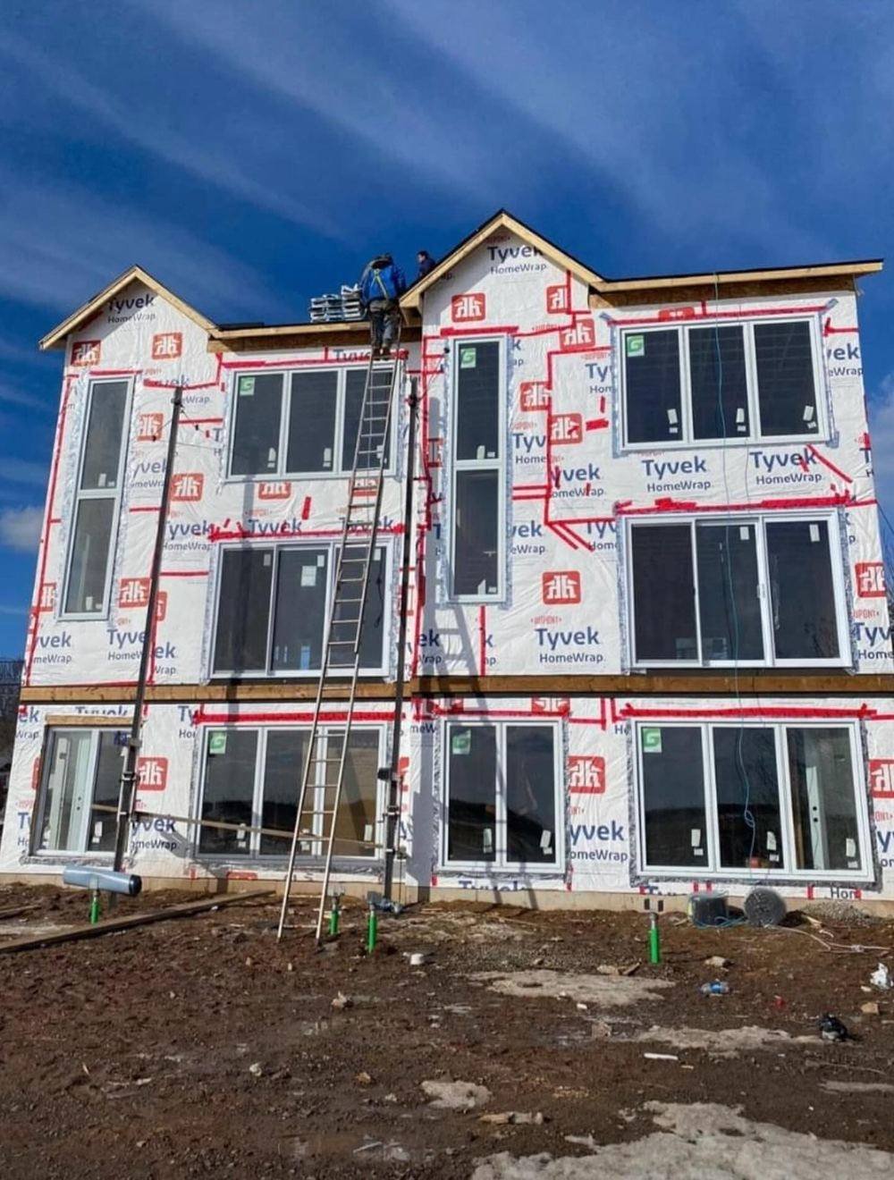 Three-storey building wrapped with windows installed