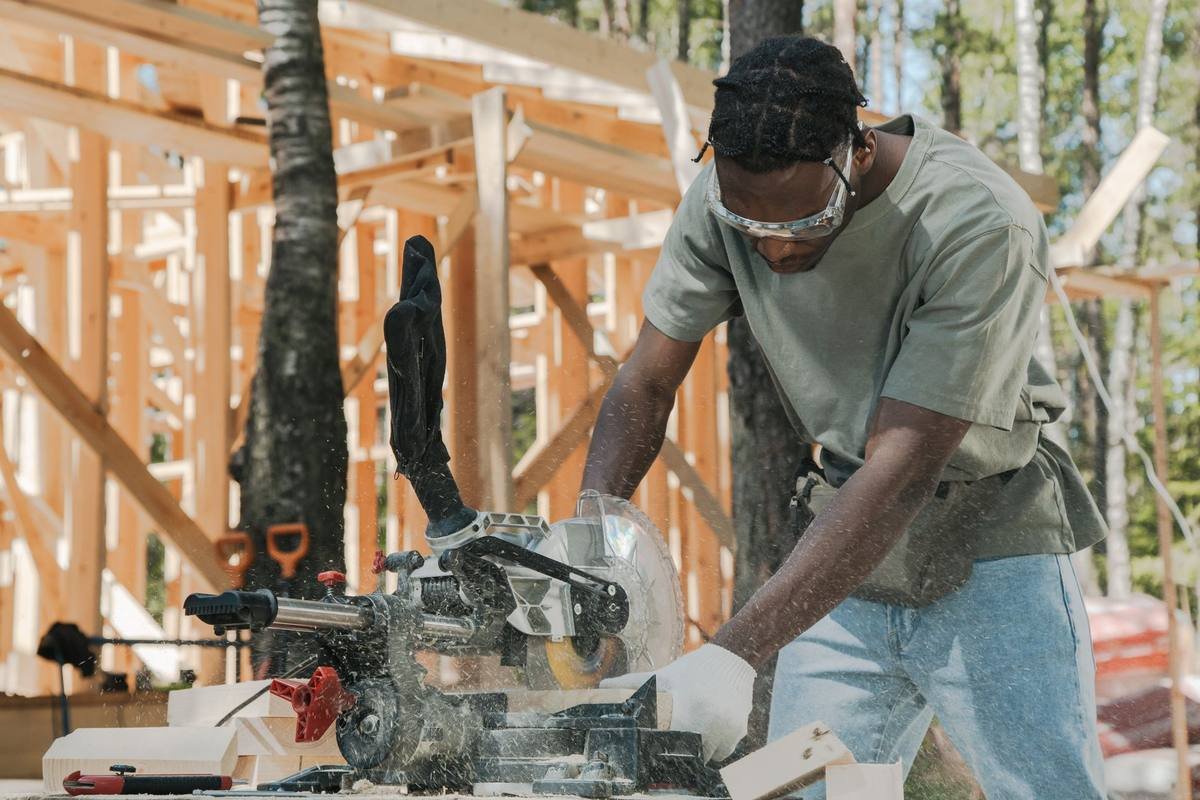 Carpenter cutting lumber on site